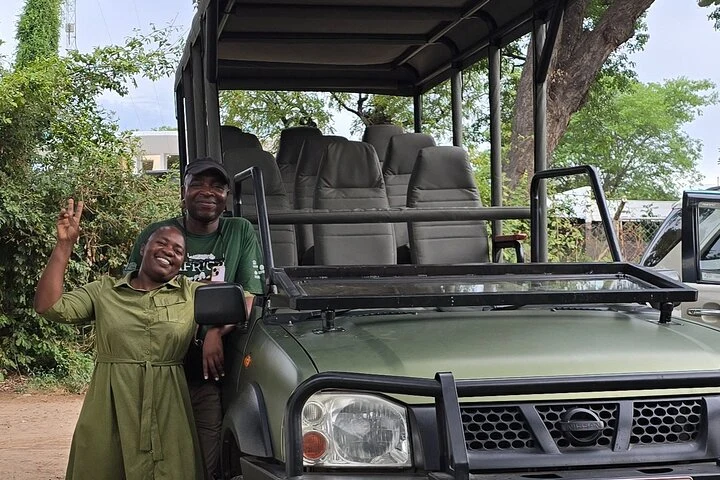 DK Tours guides beside a safari vehicle